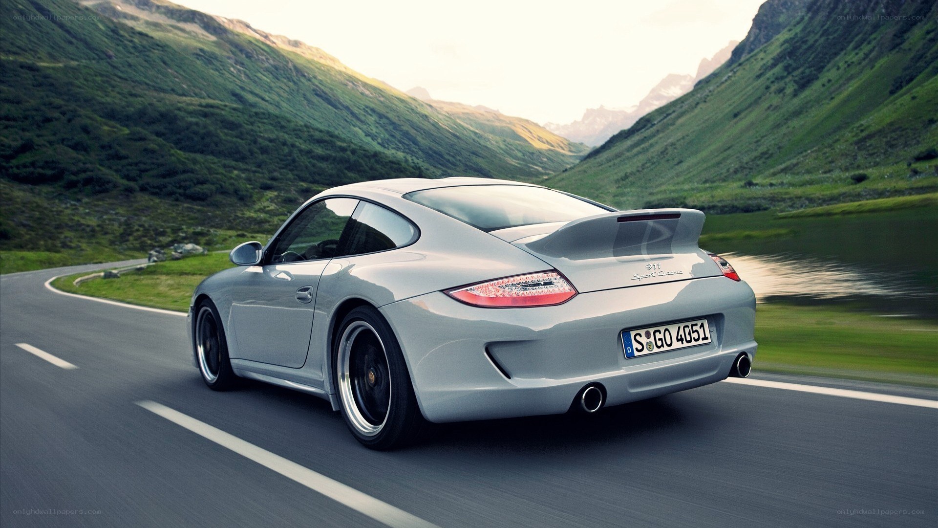 silver porsche on mountain road