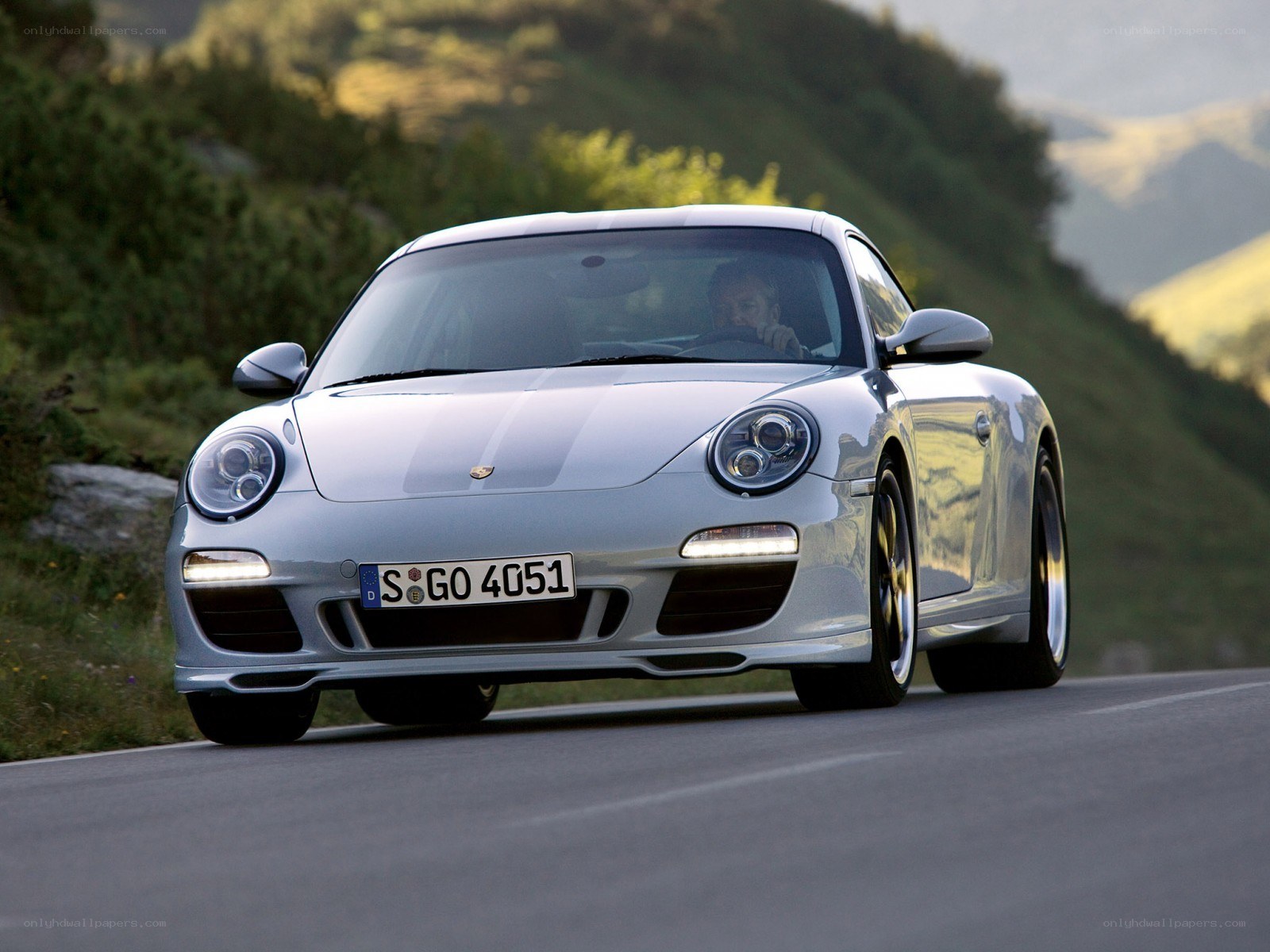 silver porsche on mountain road