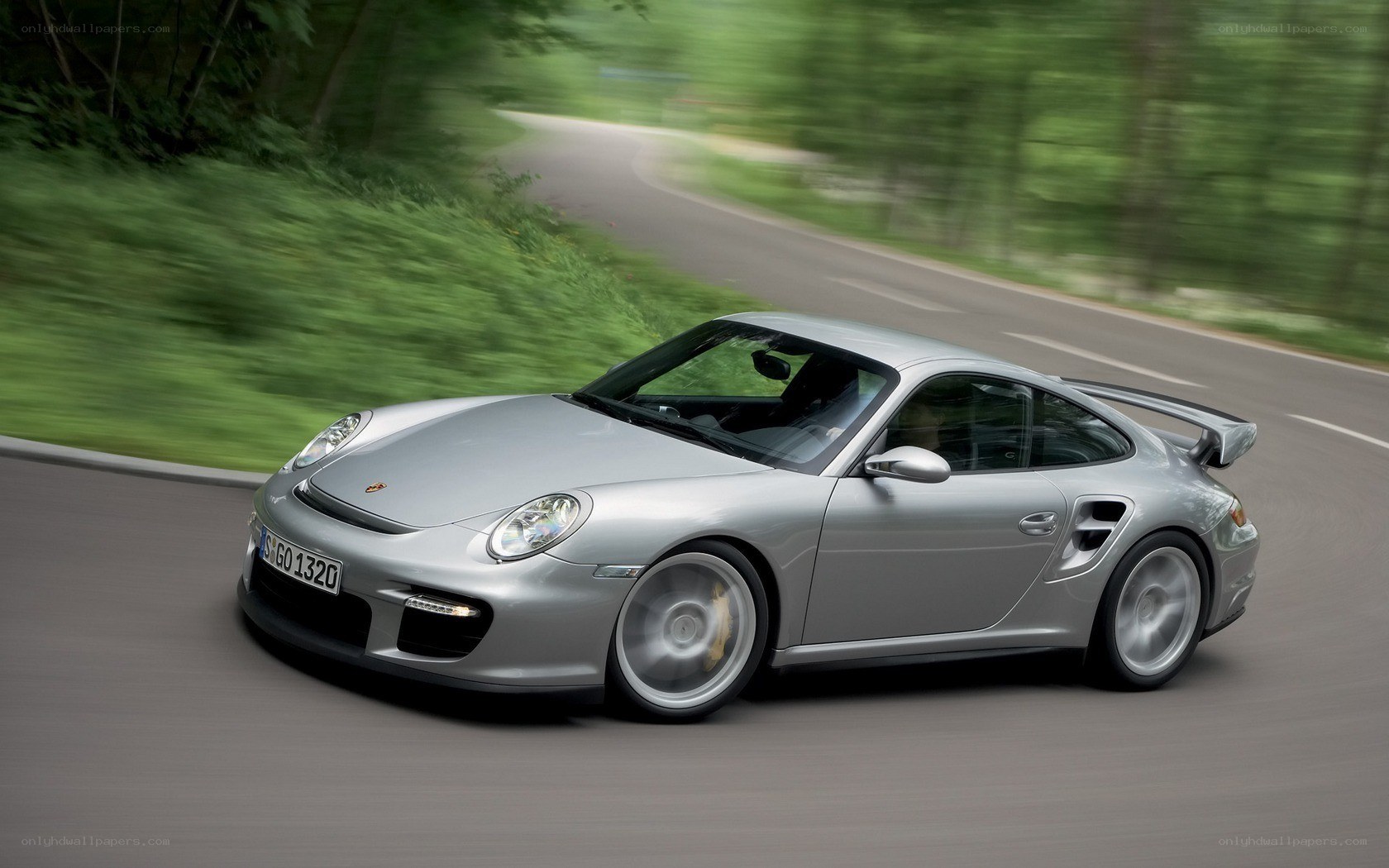 silver porsche on winding road
