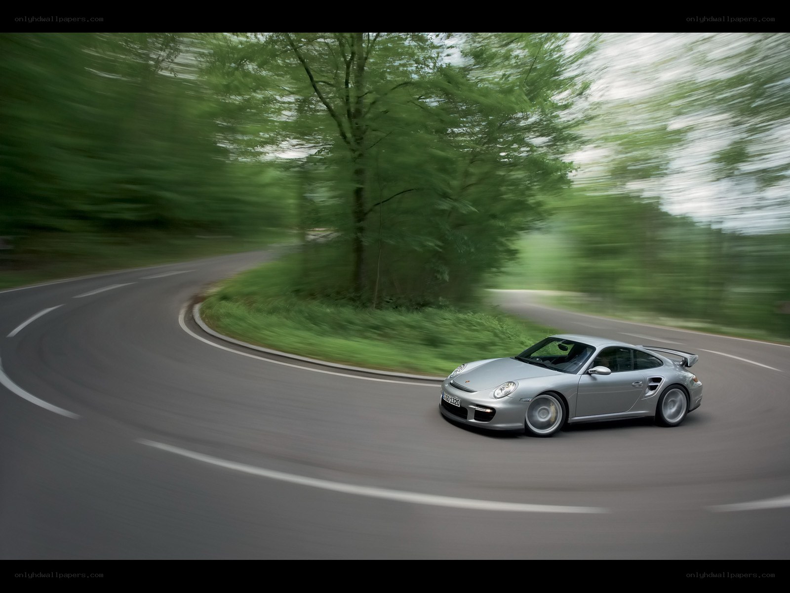 silver porsche on winding road