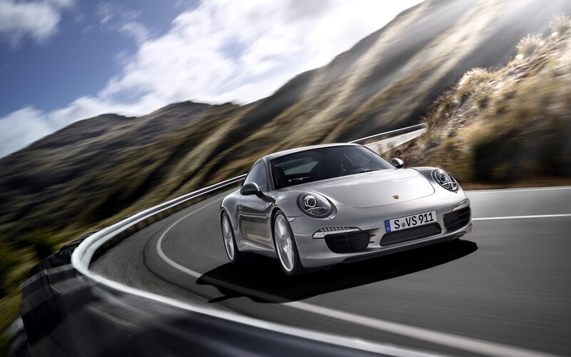 silver porsche on winding road