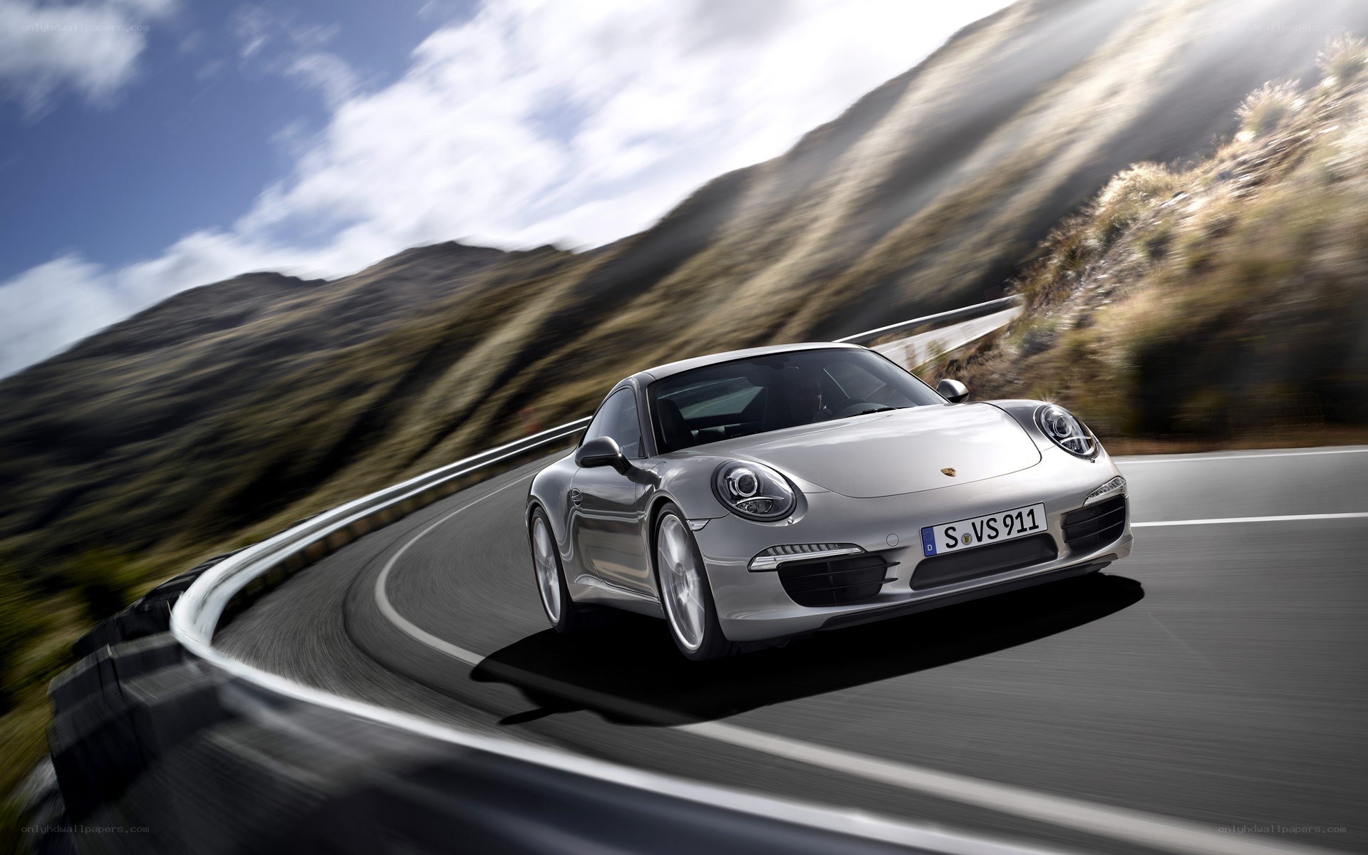 silver porsche on winding road