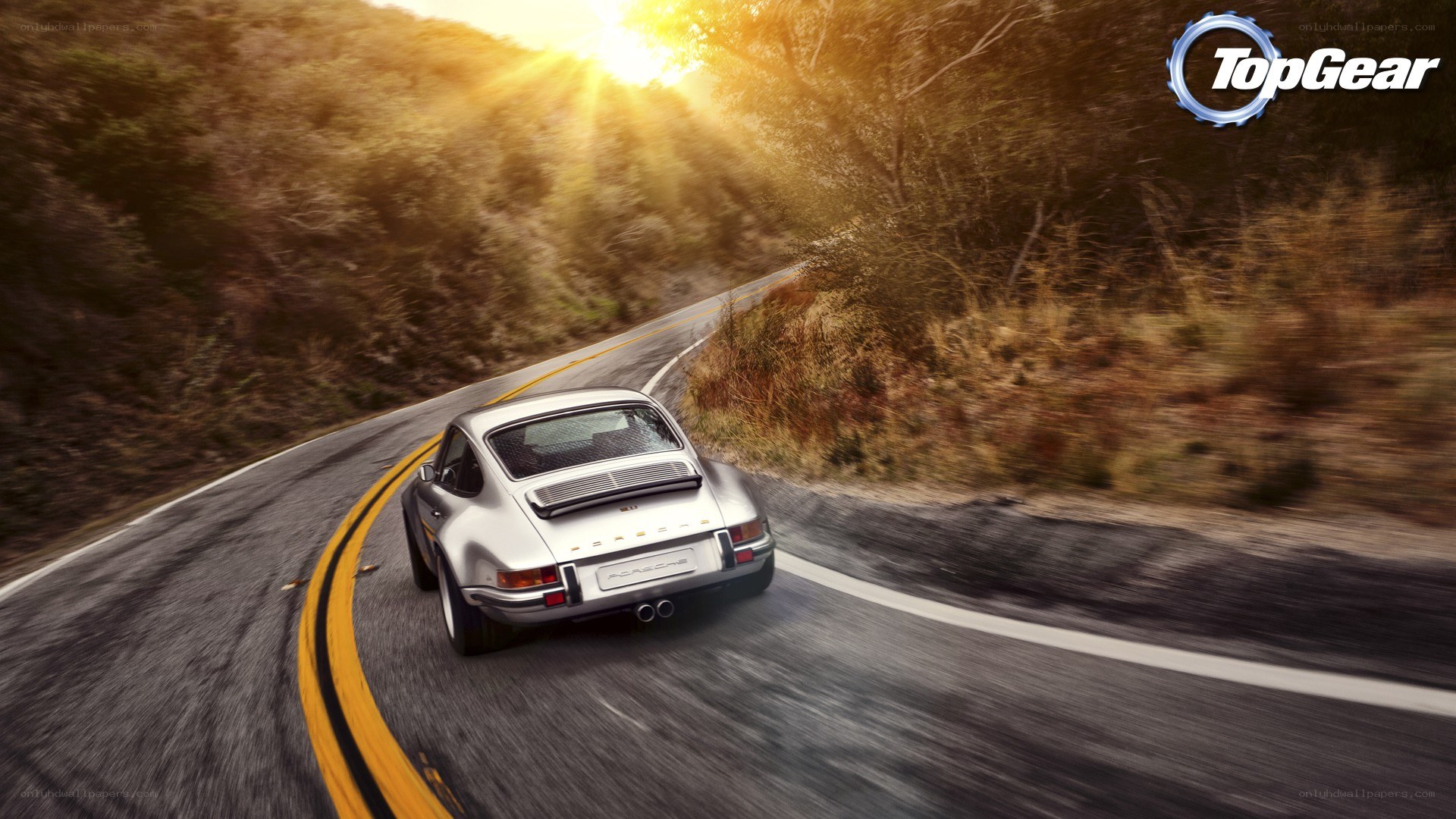 silver porsche on winding road