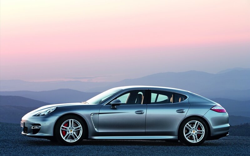 silver porsche panamera at sunset