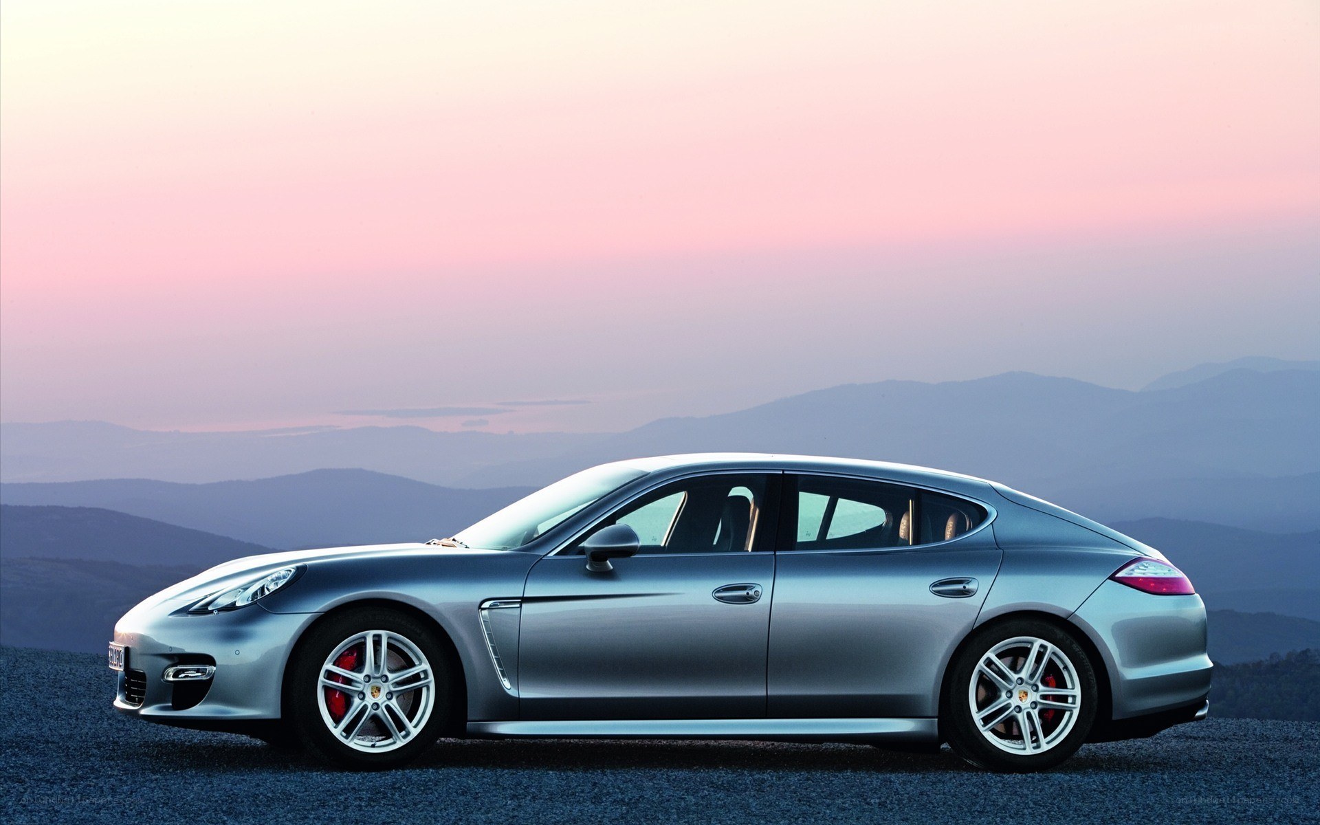silver porsche panamera at sunset