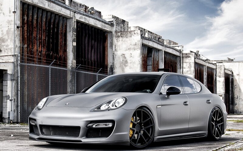 silver porsche parked in industrial area