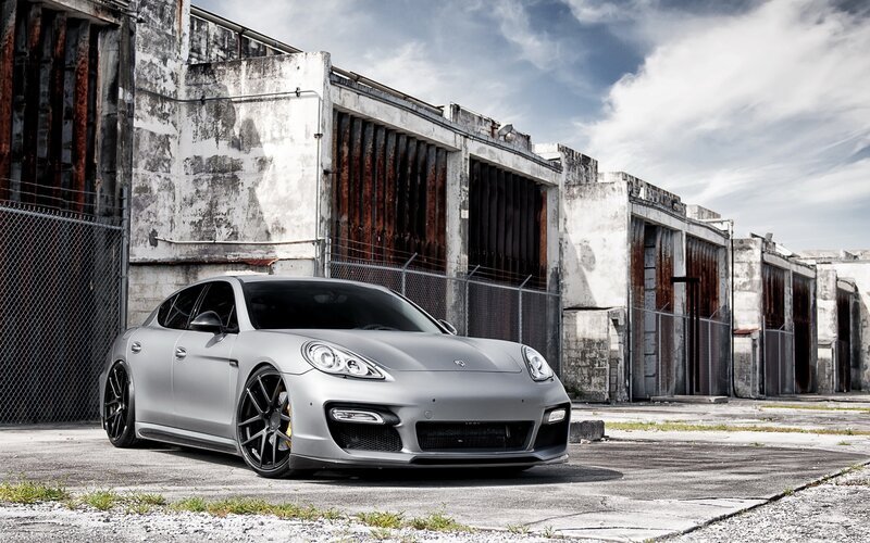 silver porsche parked in industrial lot