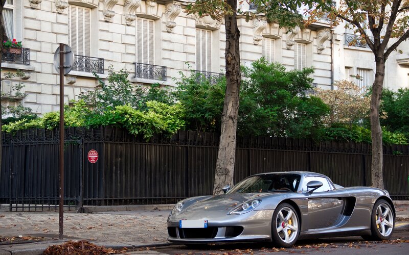Silver Porsche parked on a city street