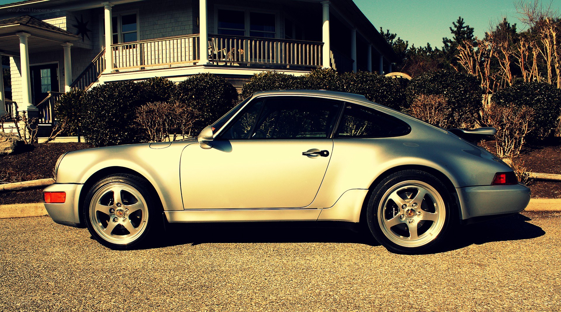 silver porsche parked outside house