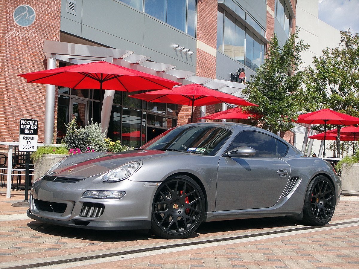 Silver Porsche parked outside restaurant