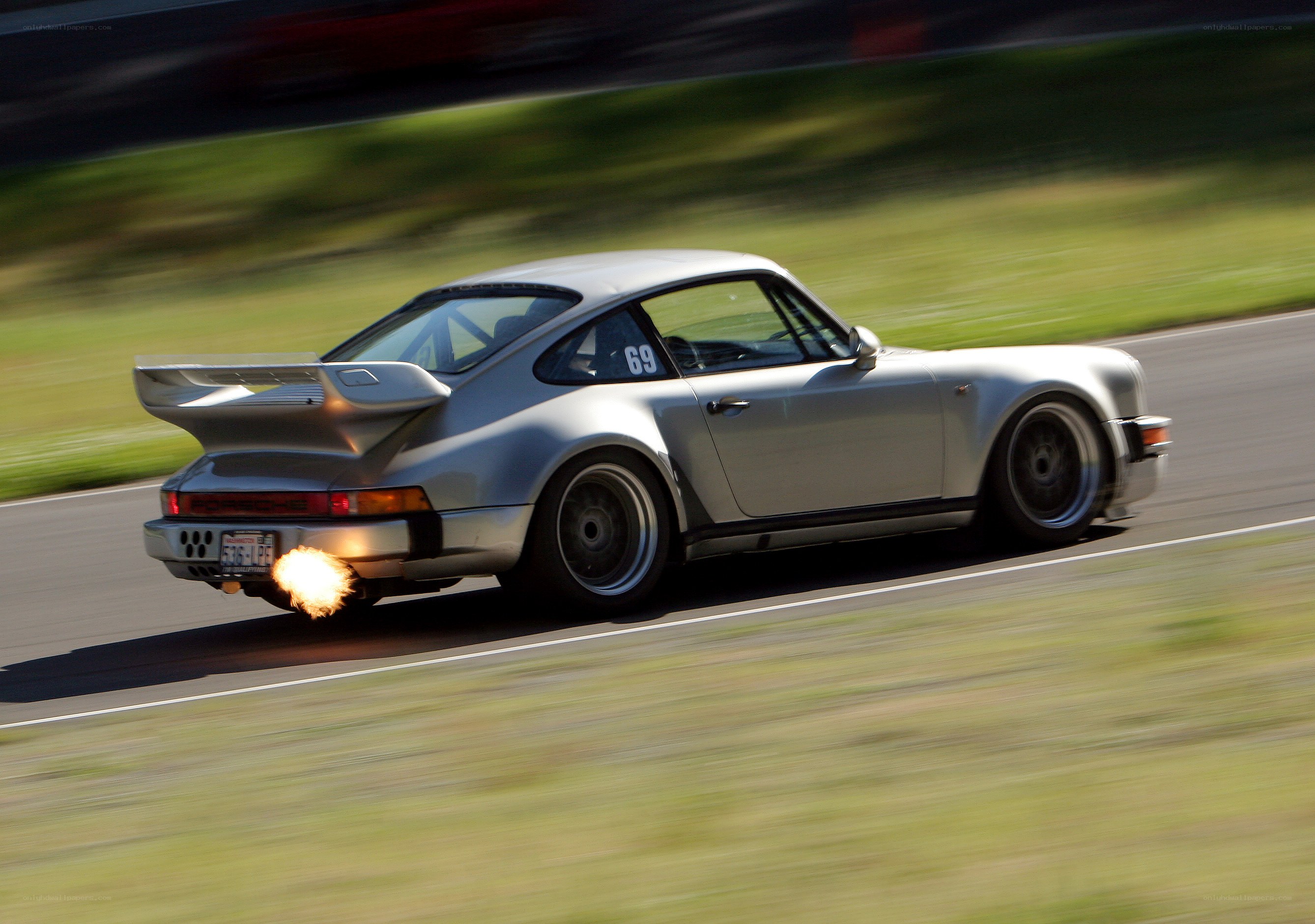 Silver Porsche racing on track