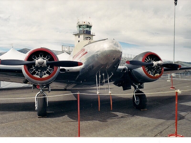 Silver Propeller Airplane — Gray, Calm, Afternoon, Photograph, Control Tower