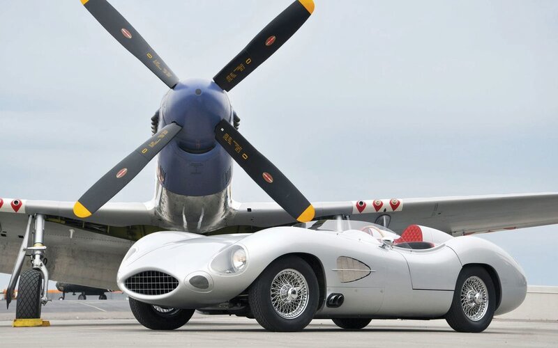 Silver race car and vintage plane