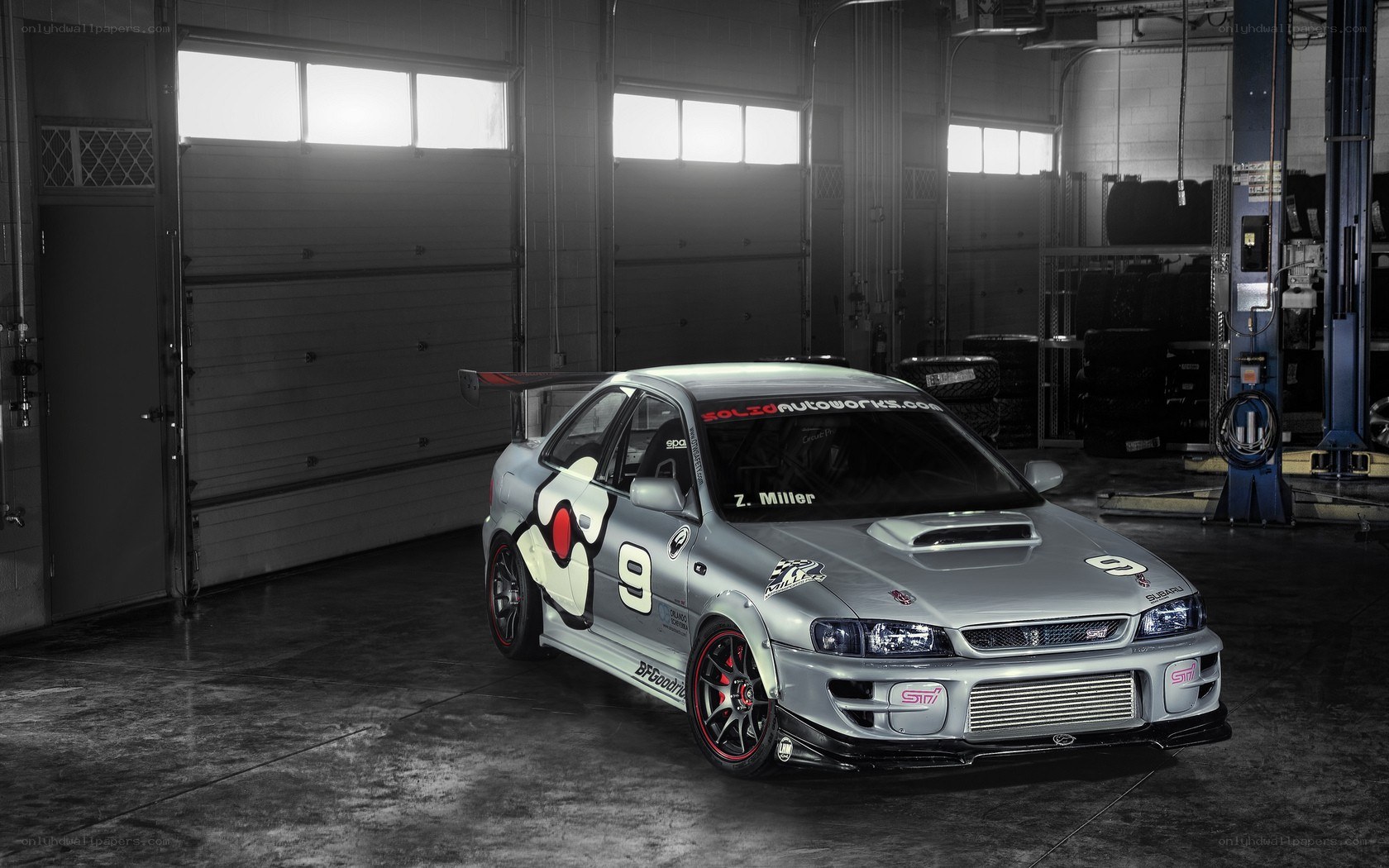 Silver race car in garage