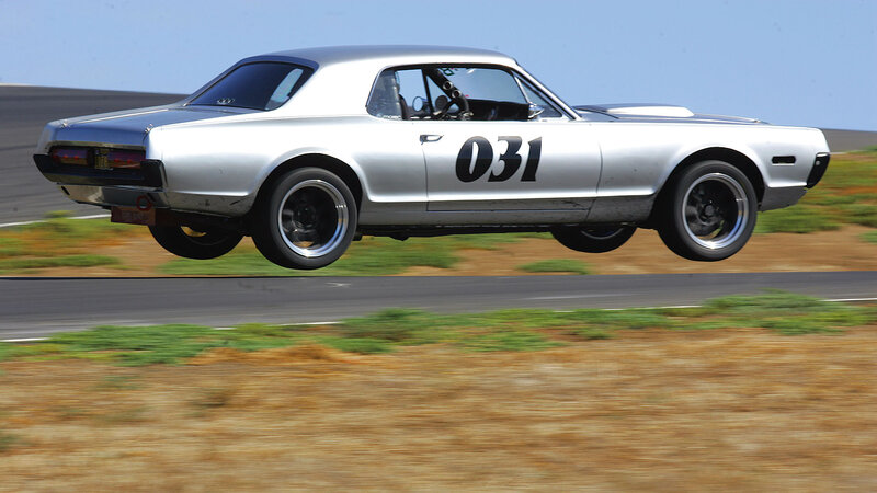 silver race car in mid-air