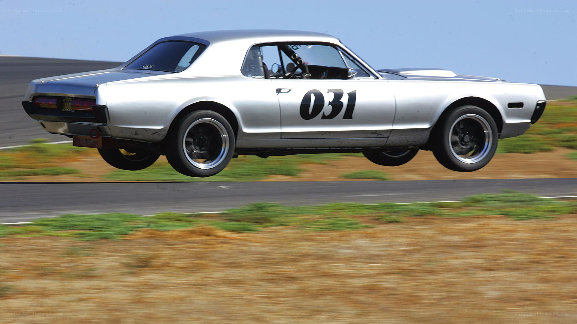 silver race car in mid-air