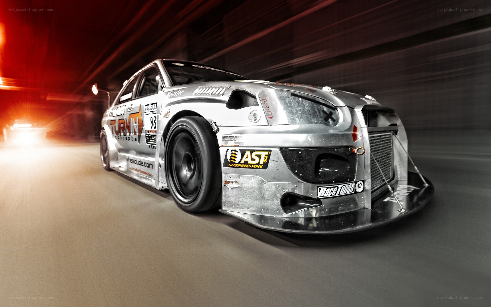 silver race car in motion