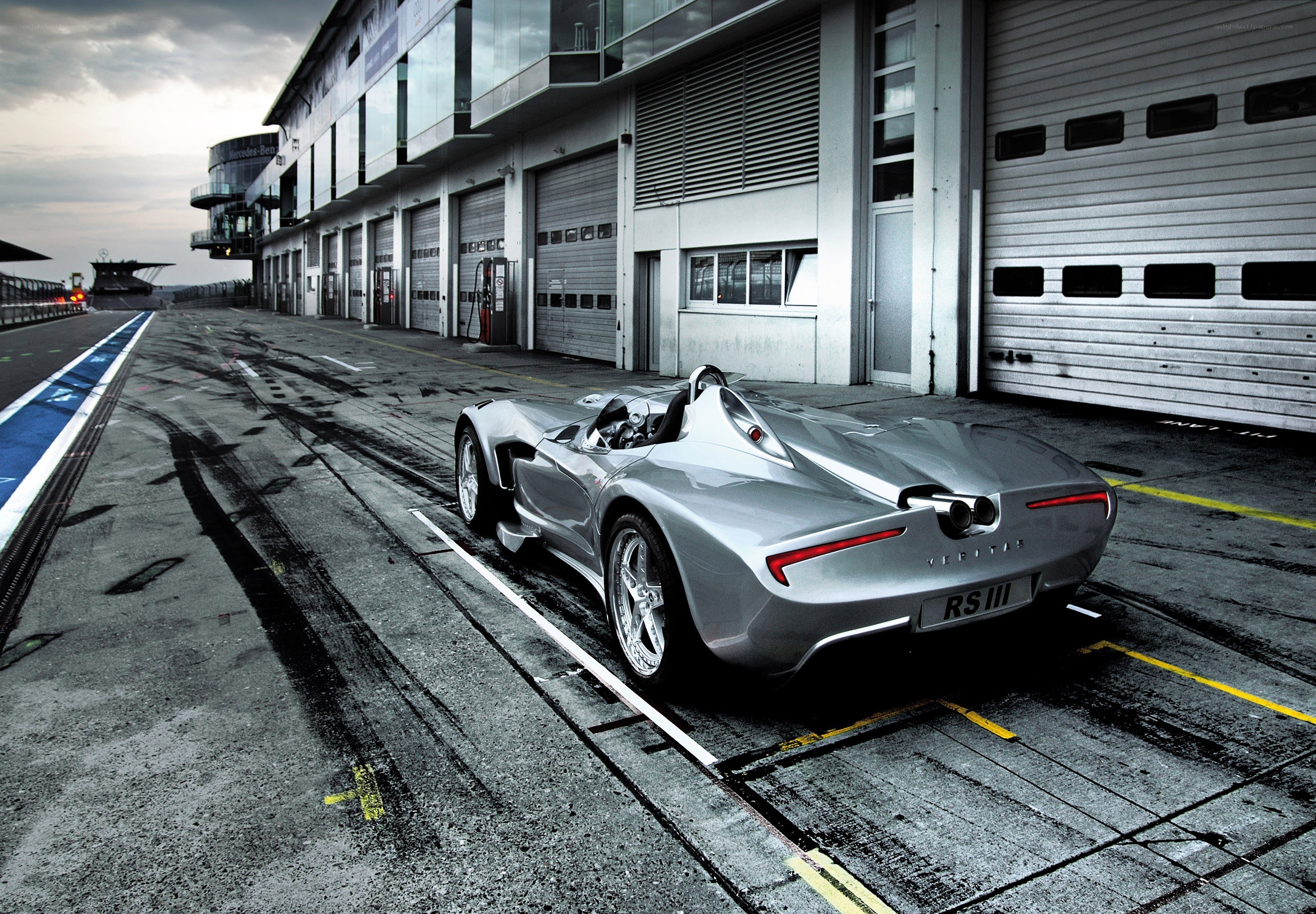 Silver race car in pit lane