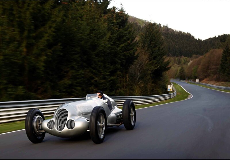 Silver race car on a winding road