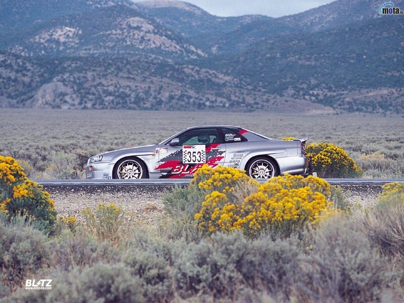 Silver race car on desert road