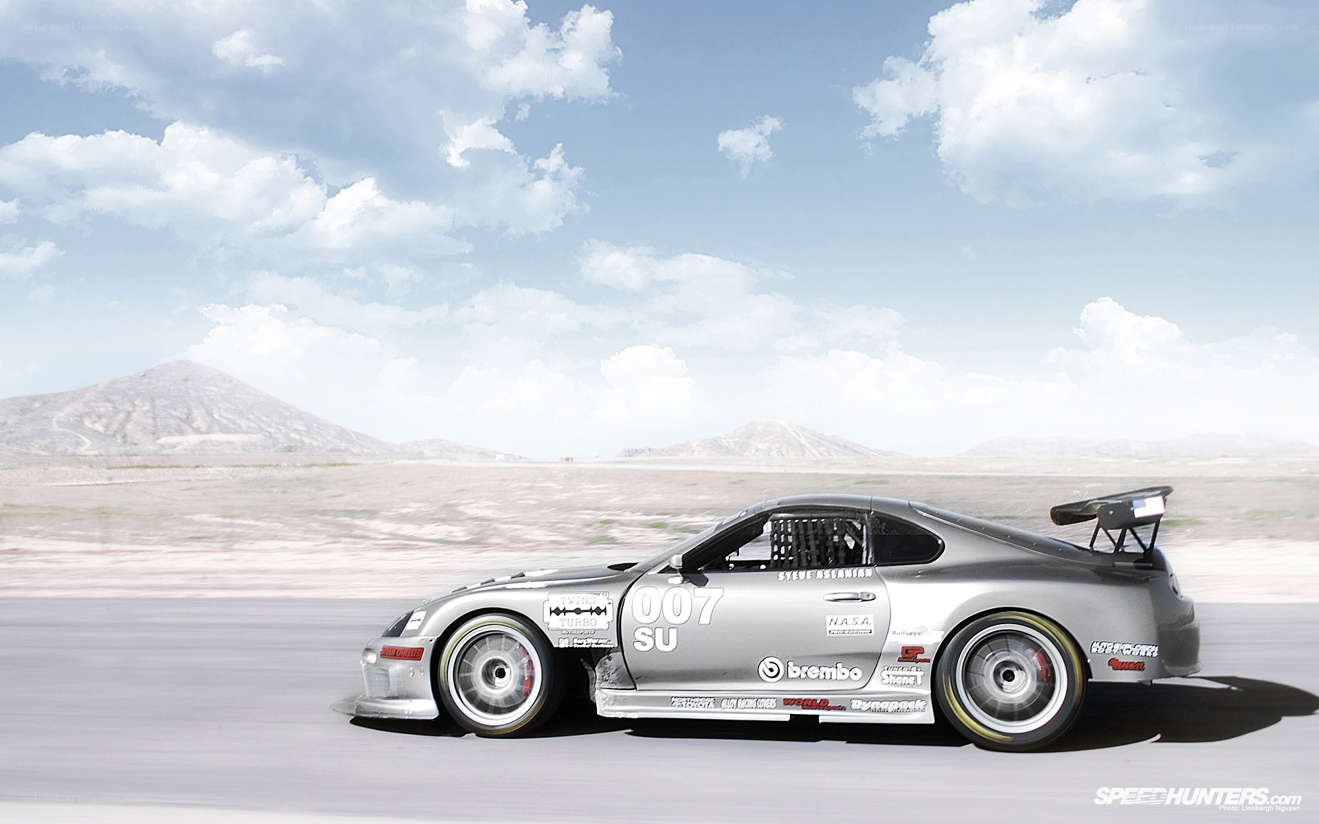 silver race car on desert track