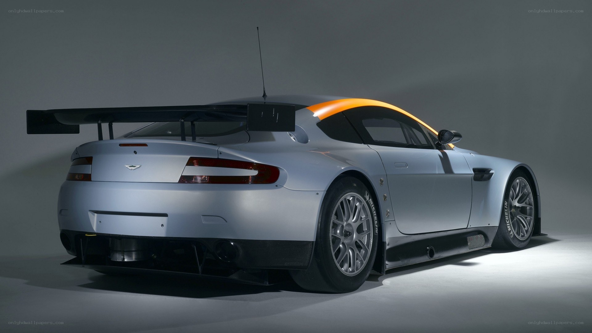 silver race car with large wing