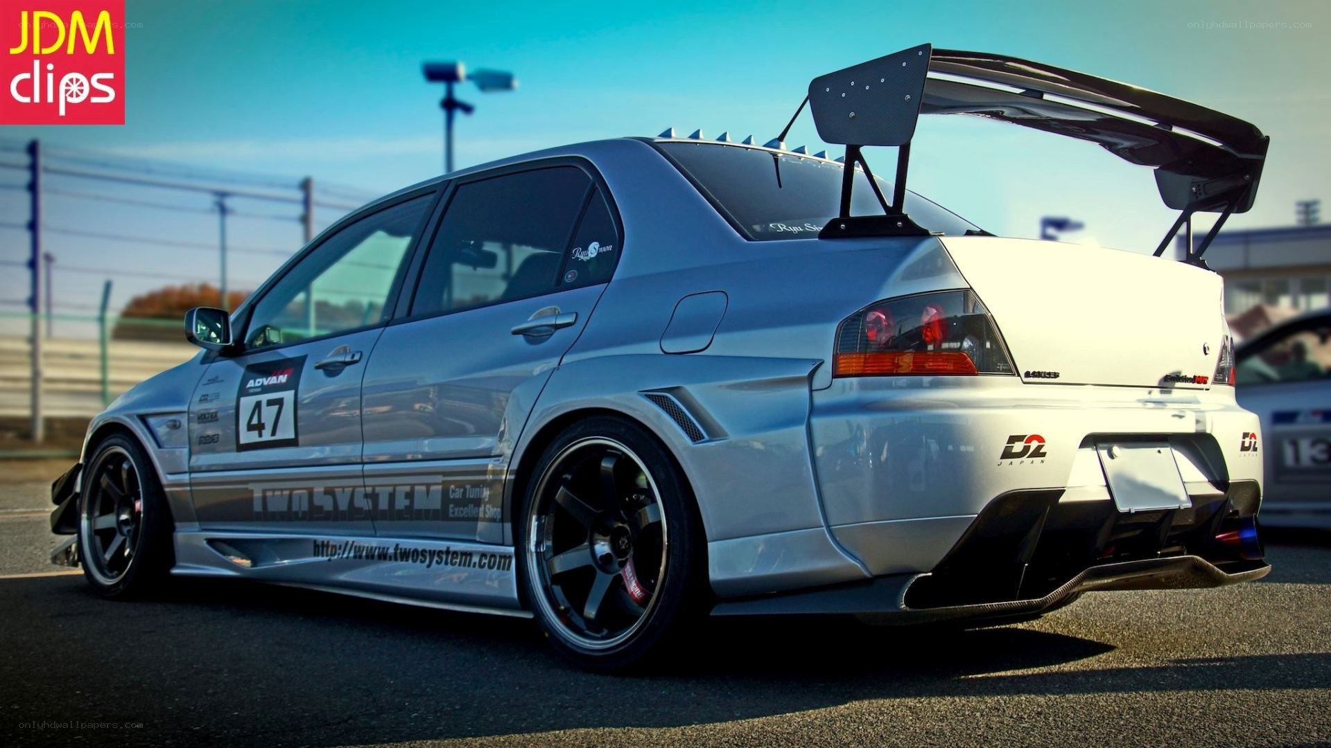 silver race car with large wing