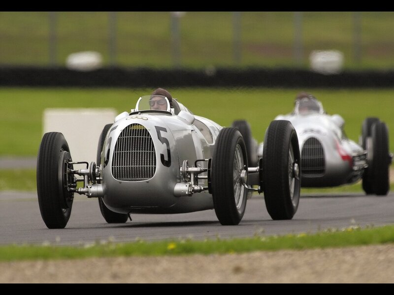 Silver race cars on track