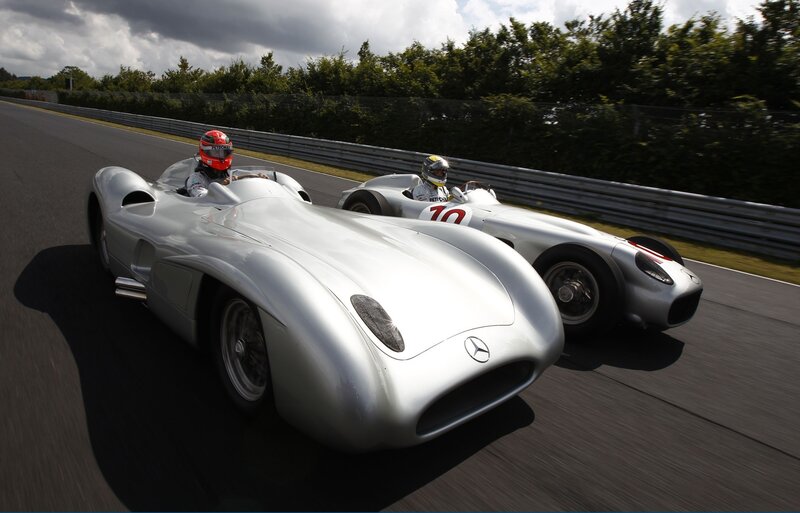 Silver race cars on track