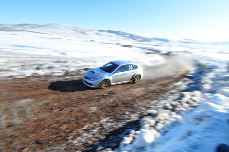 Silver rally car on snowy track