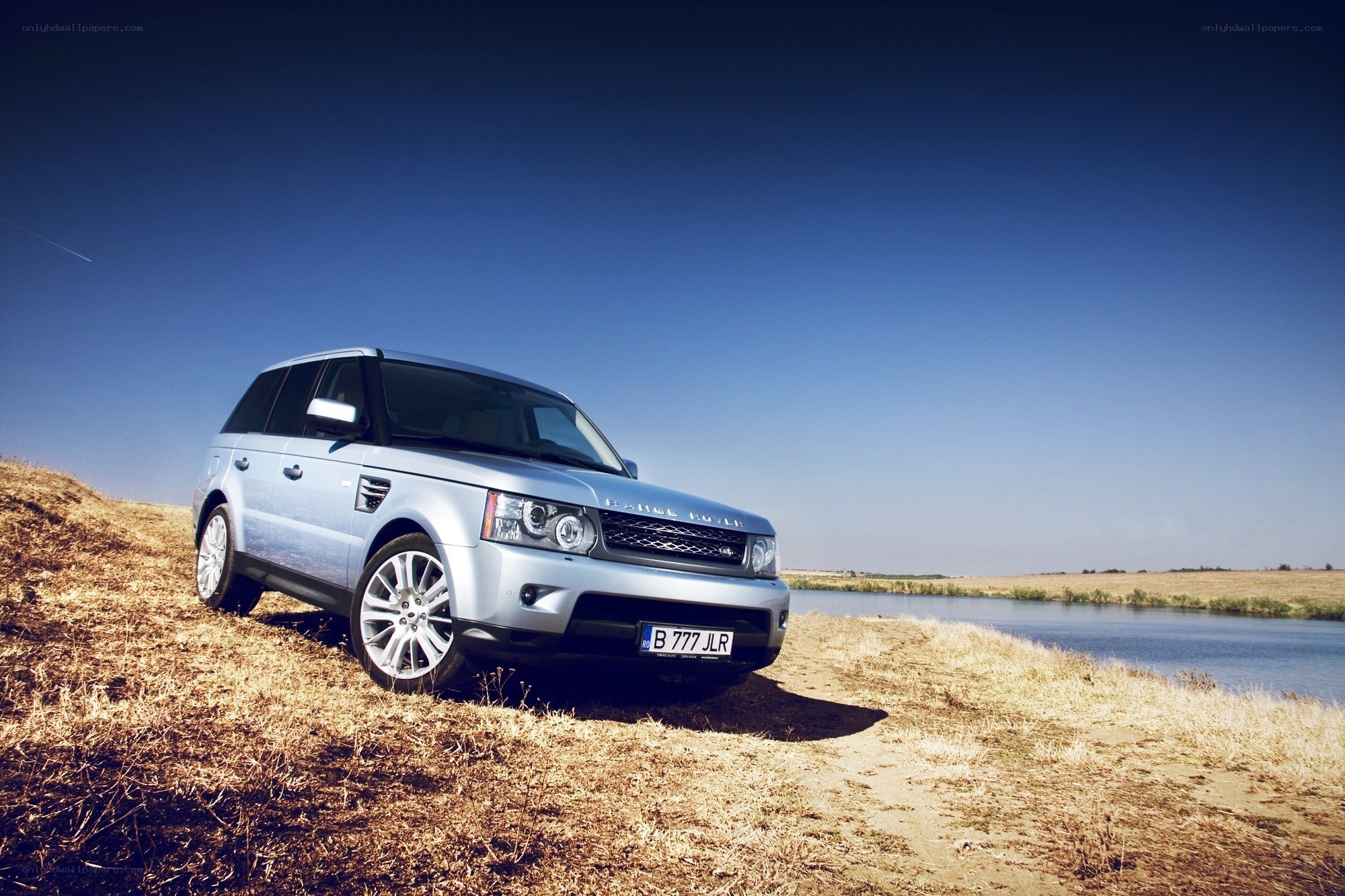 Silver Range Rover by a river