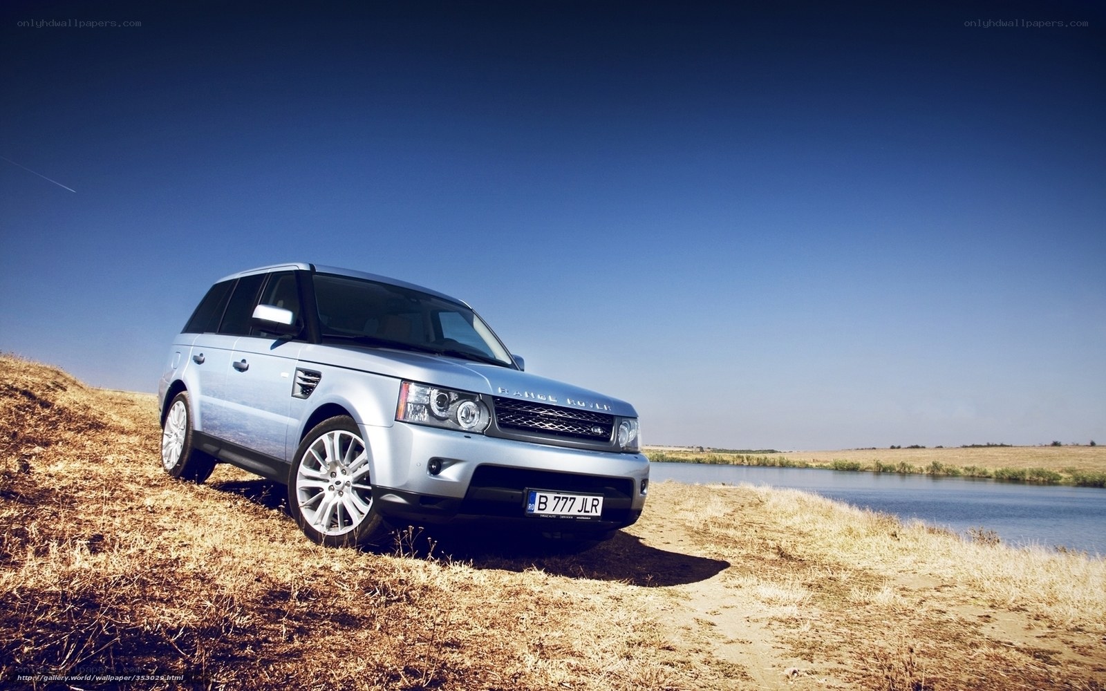 Silver Range Rover by a river