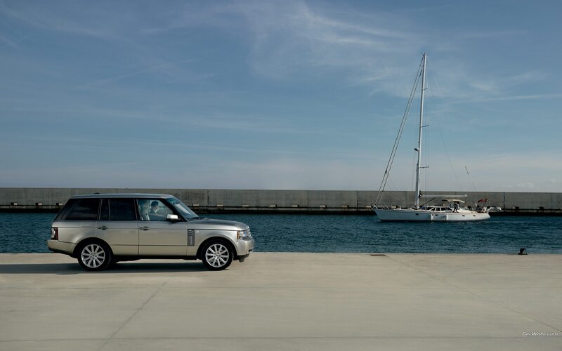 Silver Range Rover by the harbor