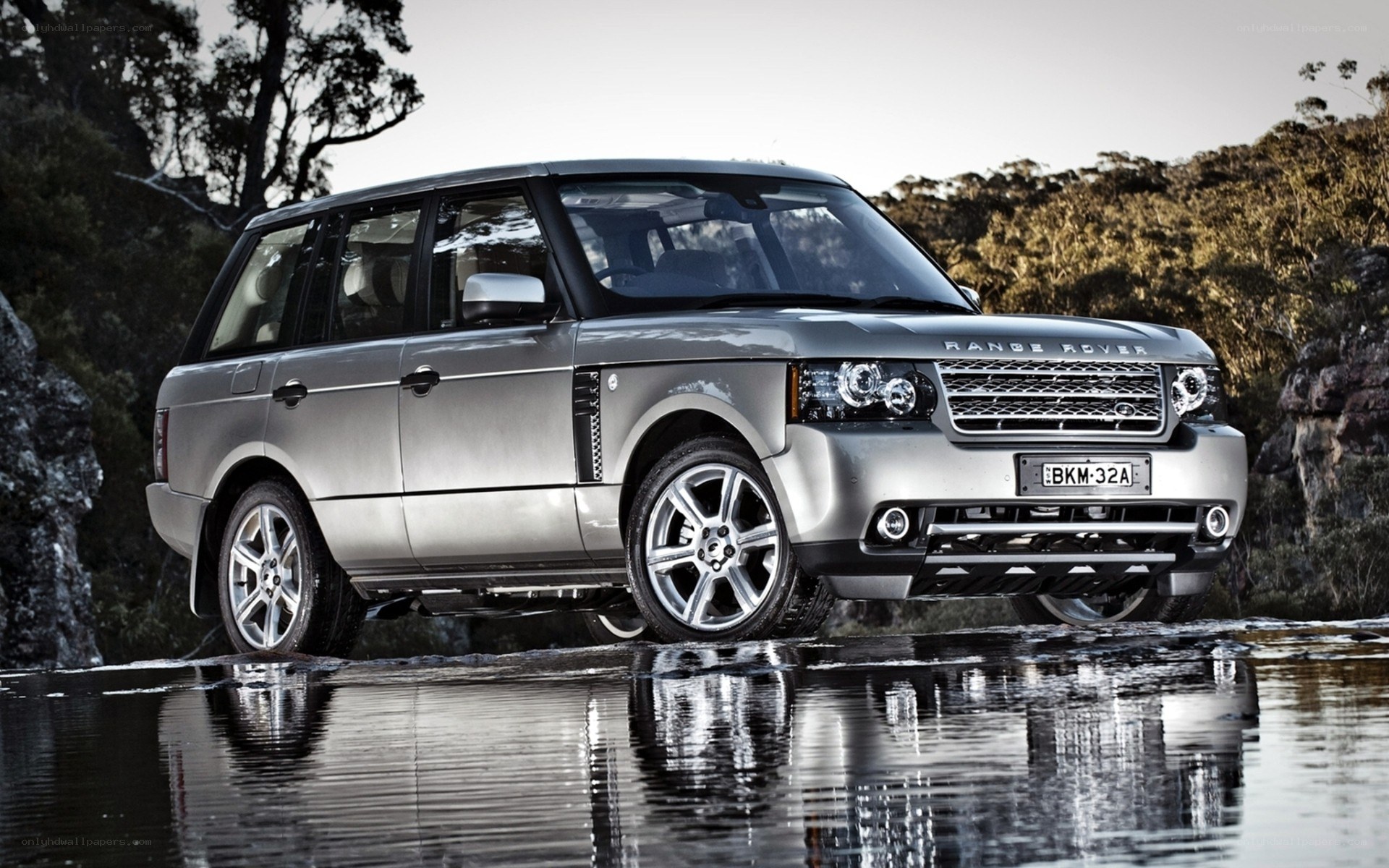 Silver Range Rover by water