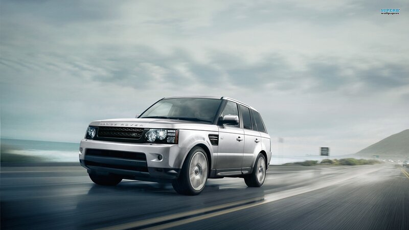 silver range rover driving on coast