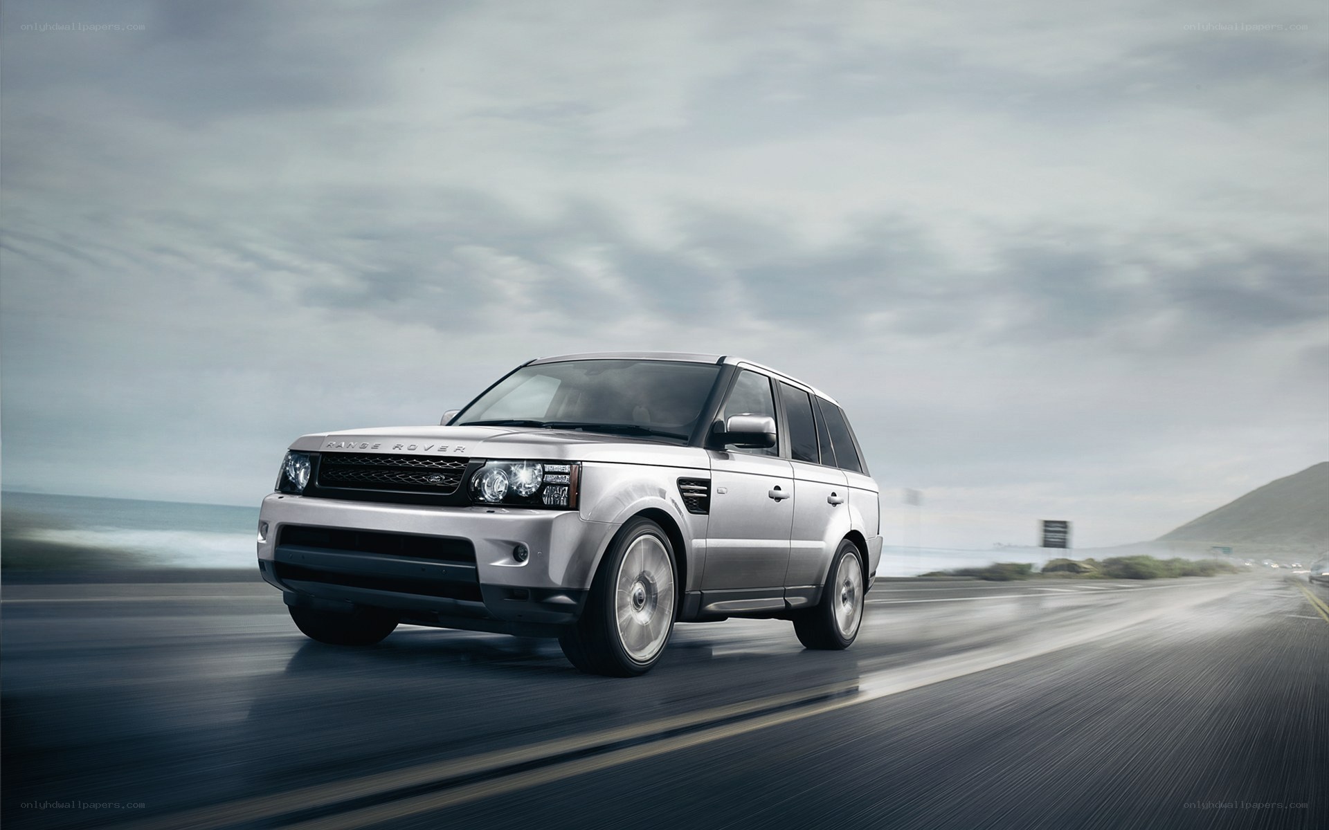 silver range rover driving on coastal road