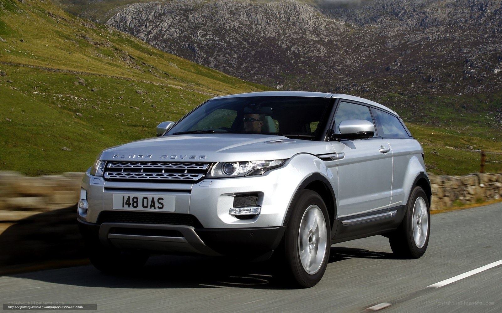 silver range rover driving on mountain road