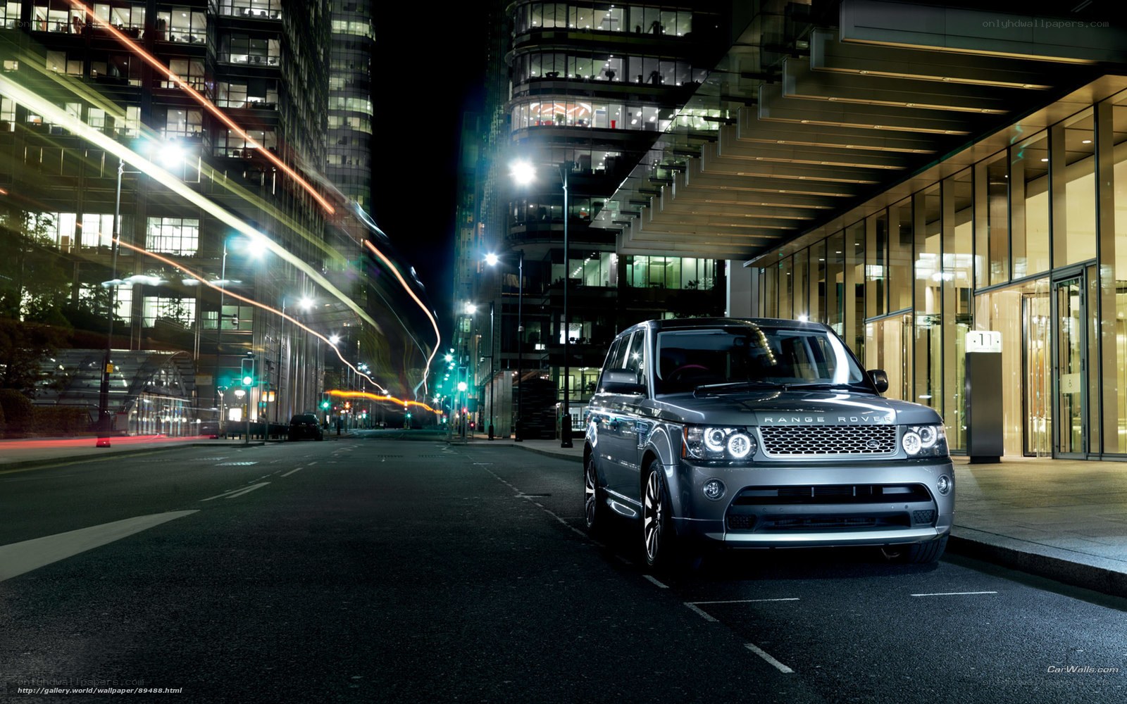 Silver Range Rover in city at night