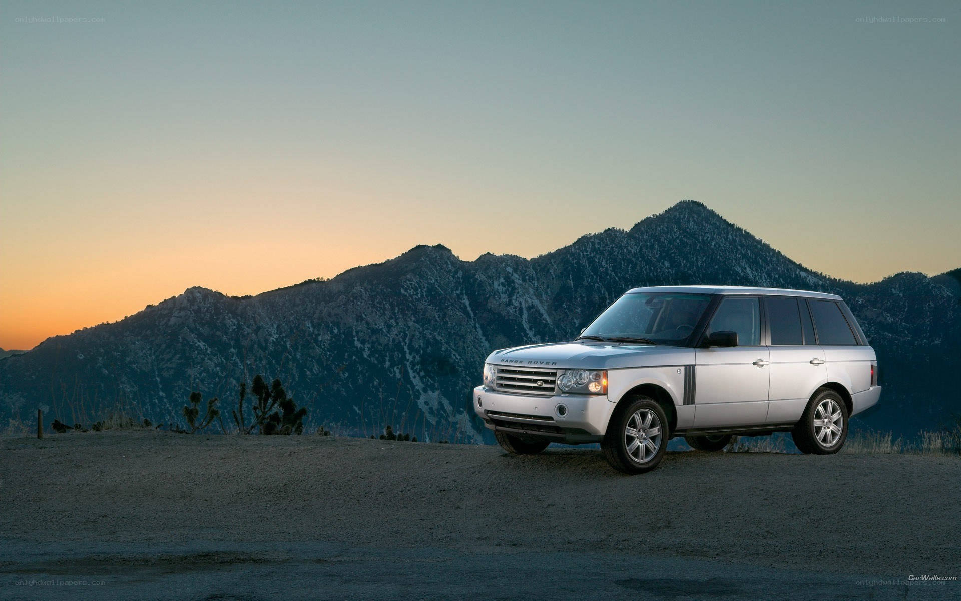 Silver Range Rover in mountain landscape