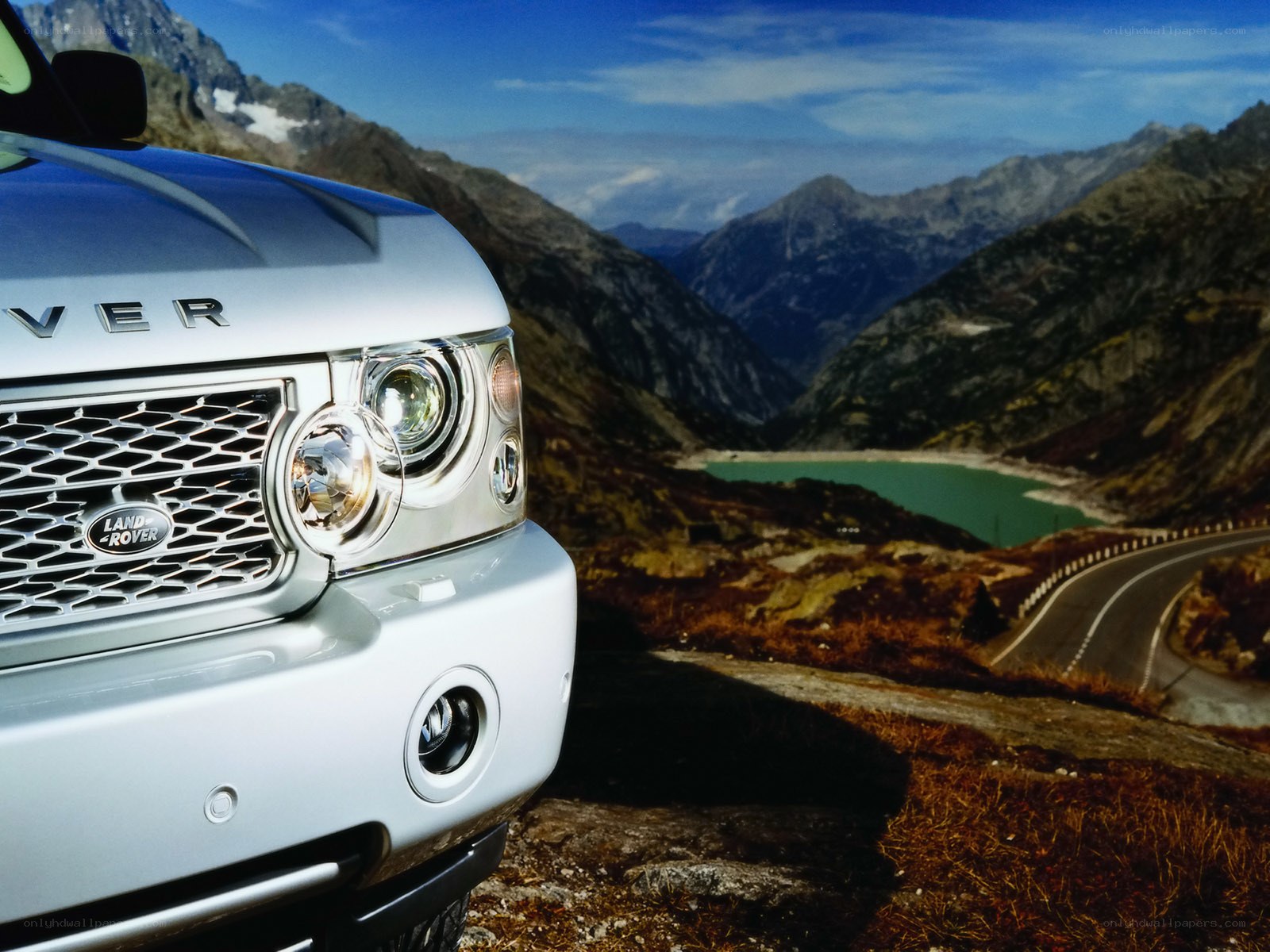 Silver Range Rover in mountain landscape