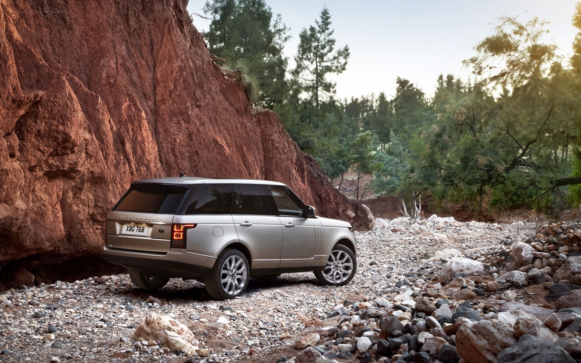Silver Range Rover in rocky terrain