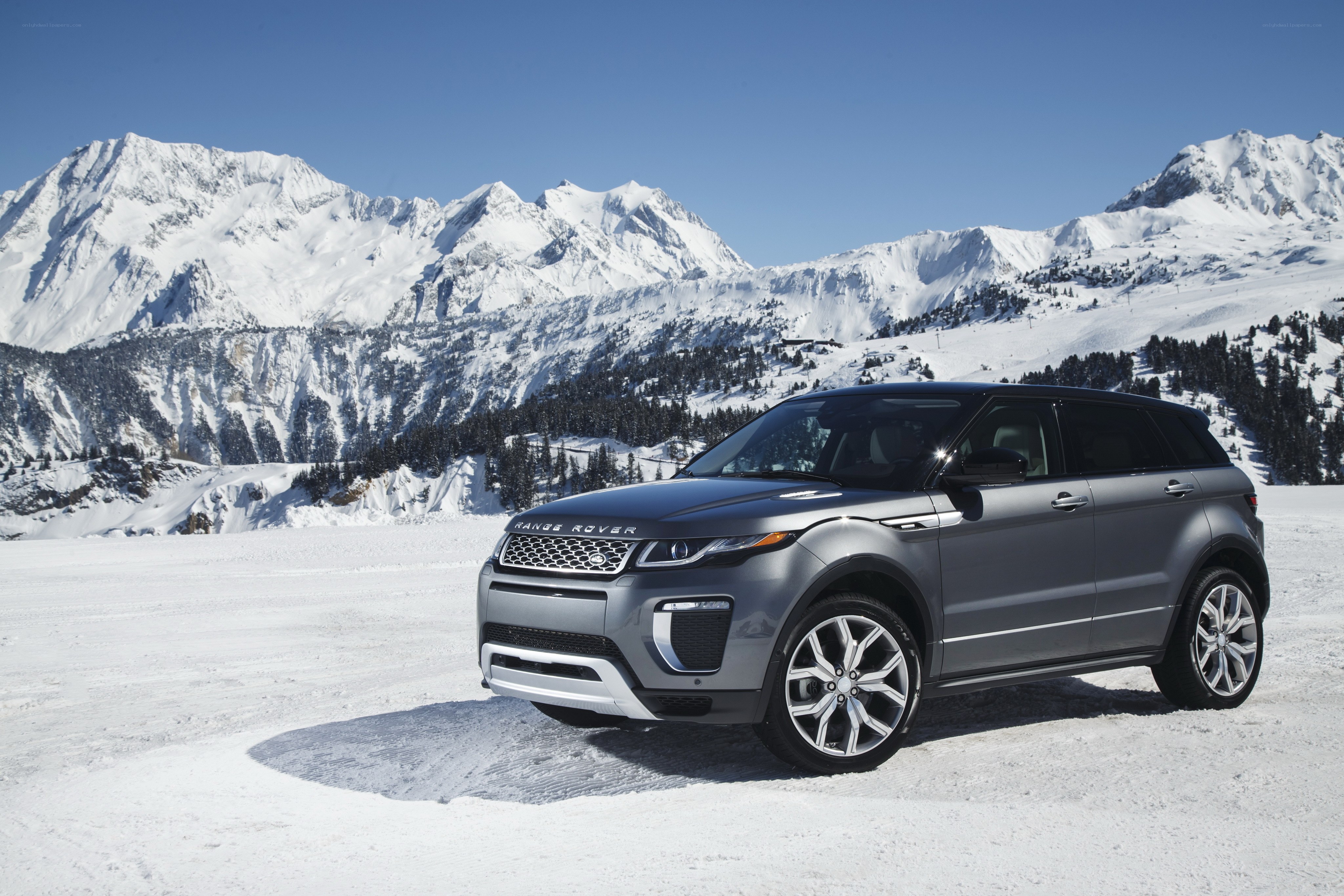 Silver Range Rover in snowy mountains
