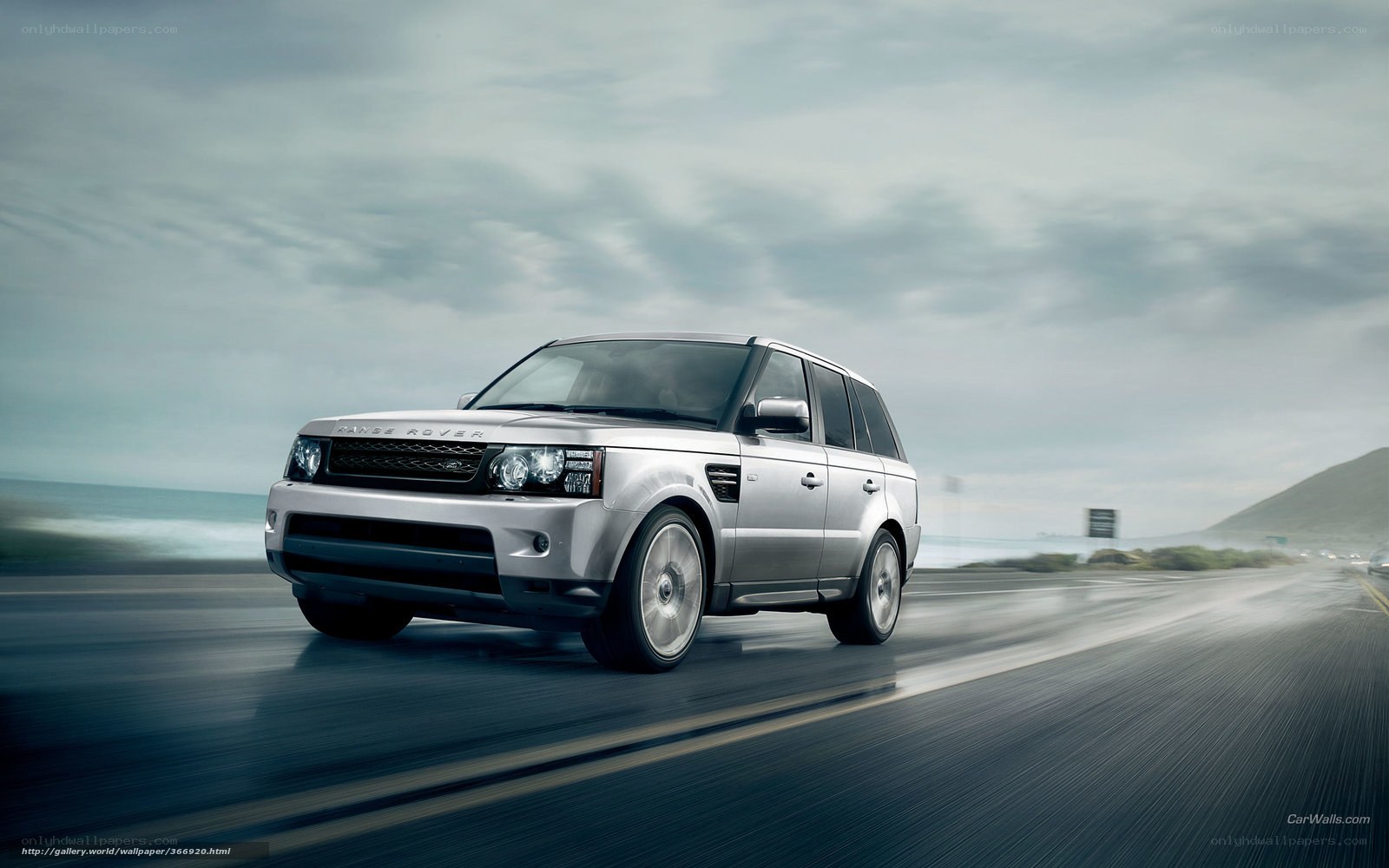 silver range rover on coastal road