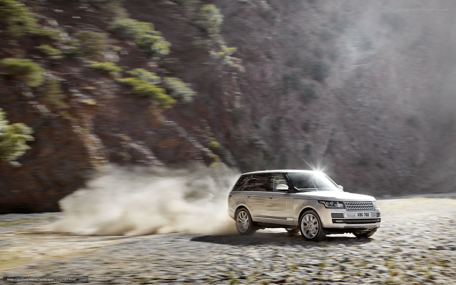 Silver Range Rover on dusty road