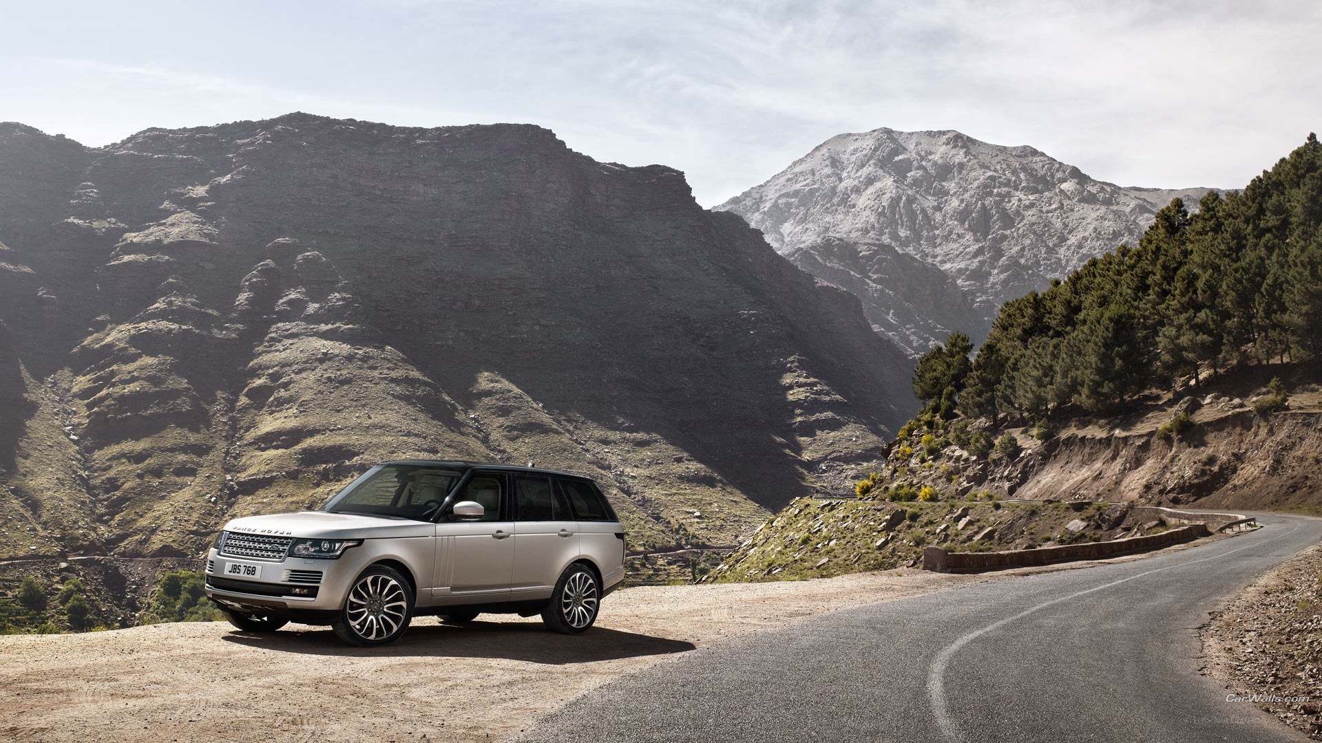 Silver Range Rover on mountain road