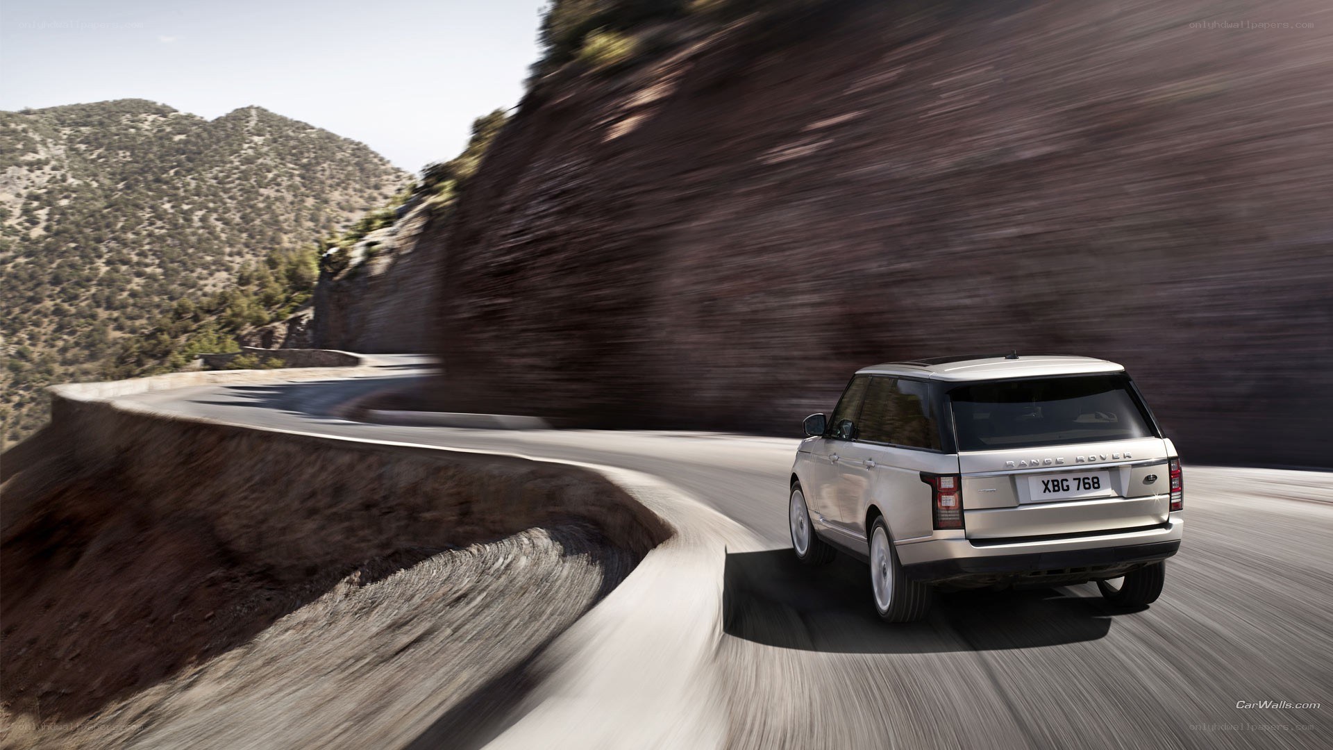 silver range rover on mountain road