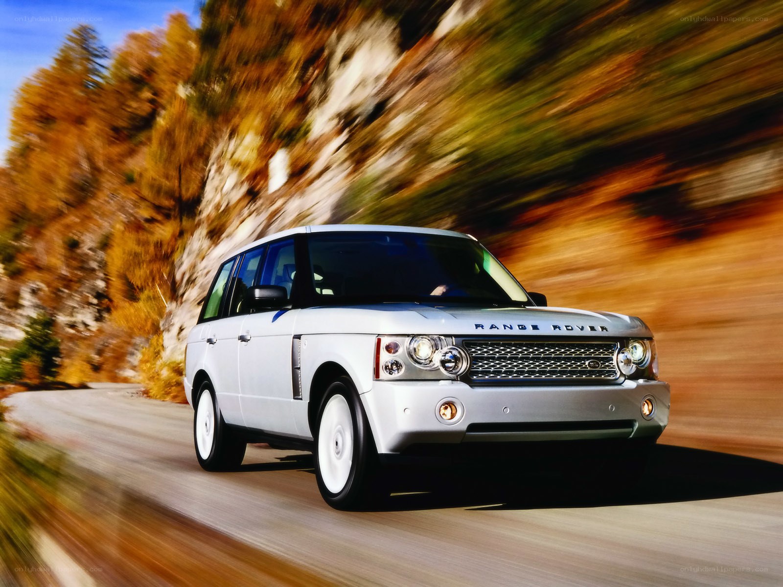 Silver Range Rover on mountain road