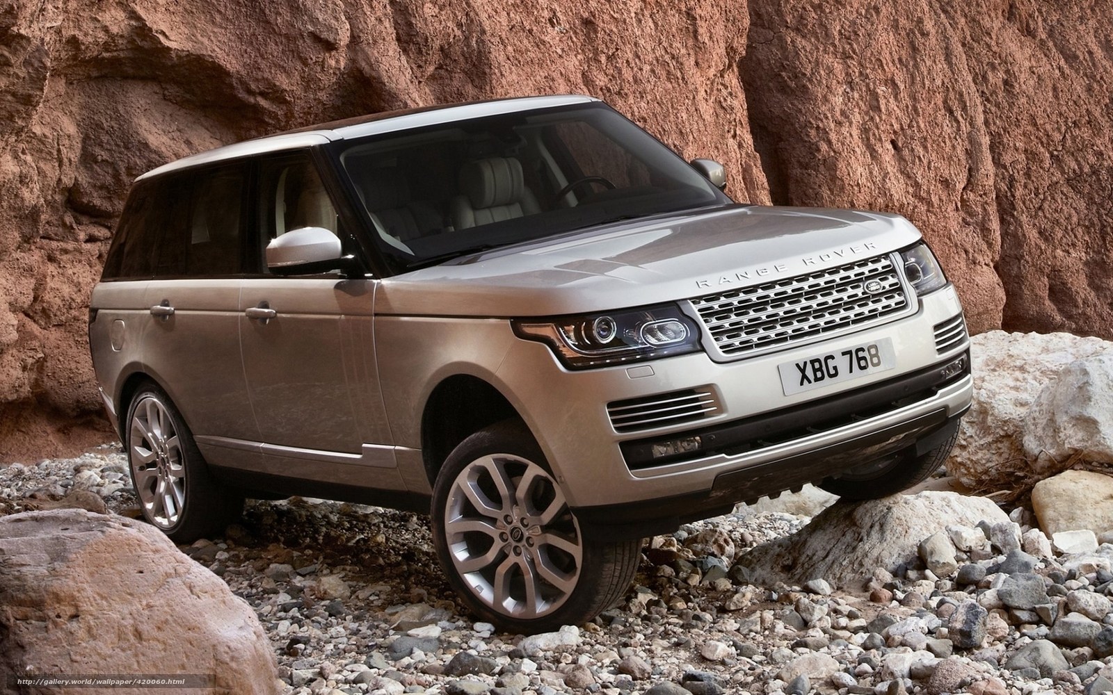 Silver Range Rover on rocky terrain