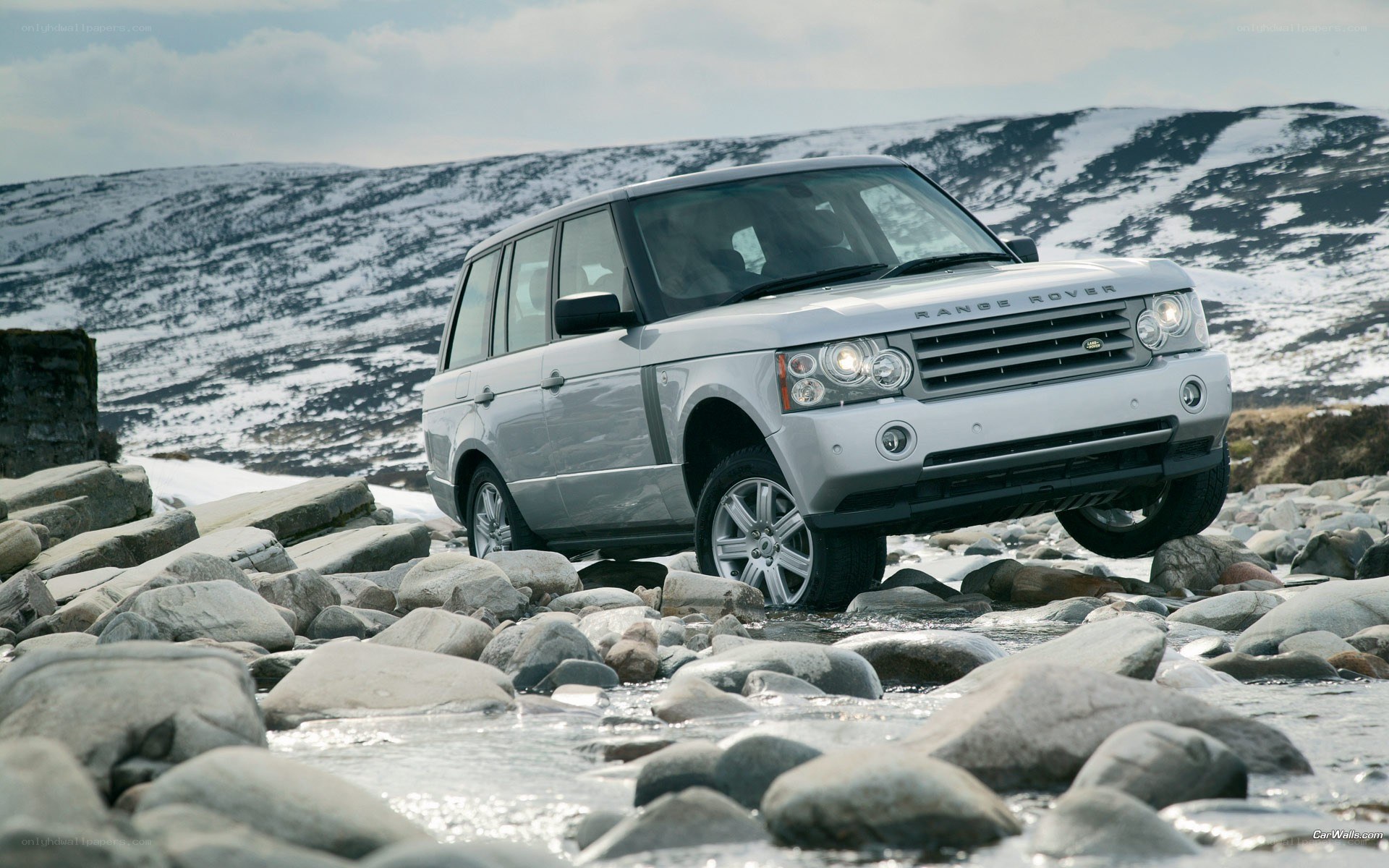 Silver Range Rover on rocky terrain