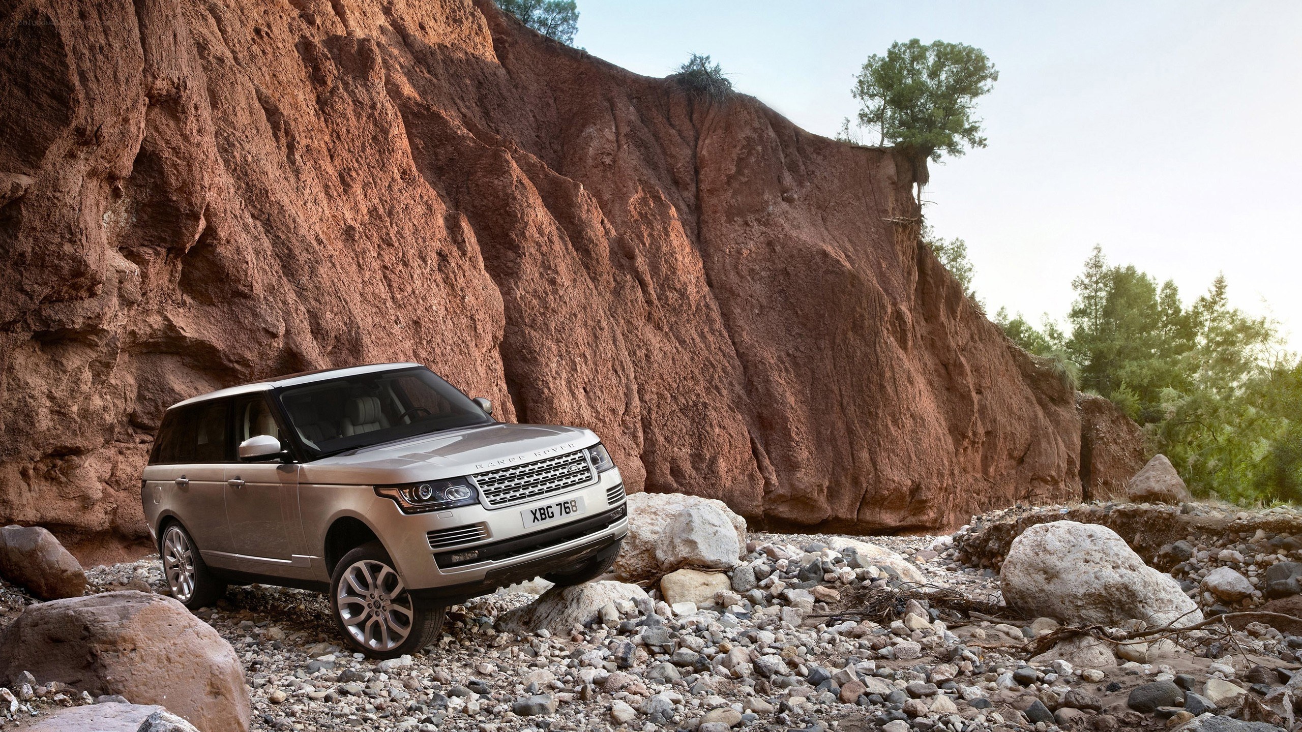 Silver Range Rover on rocky terrain